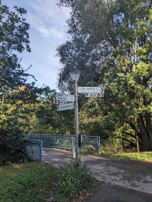 Fahrradwegweiser an der Fußgängerbrücke von Lobeda West nach Göschwitz, Bäume Himmel